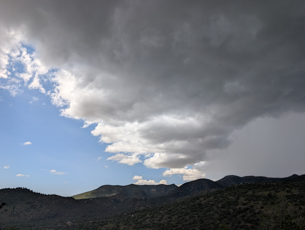Dark storm front crossing mountain ridges