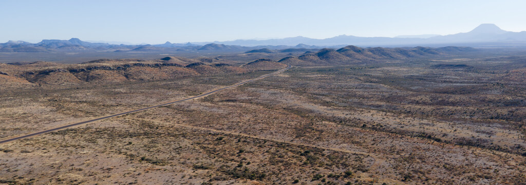 Wide desert plain and layered distant ridges