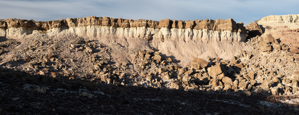 Pale cliff above a field of broken rock