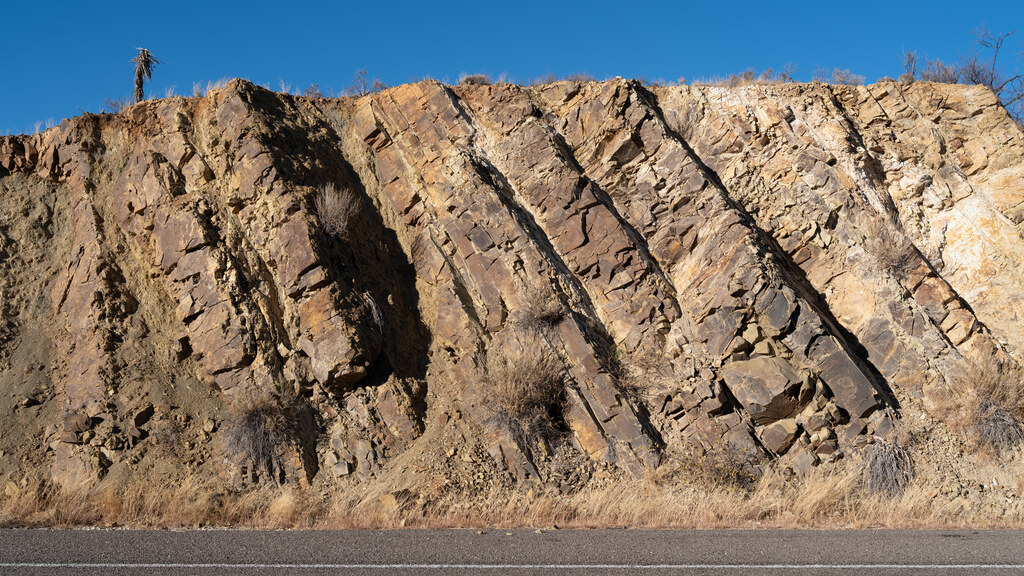 Sharply tilted pink and brown rock beds