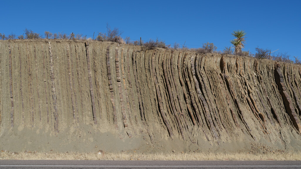 Roadcut exposing closely spaced vertical sediment layers